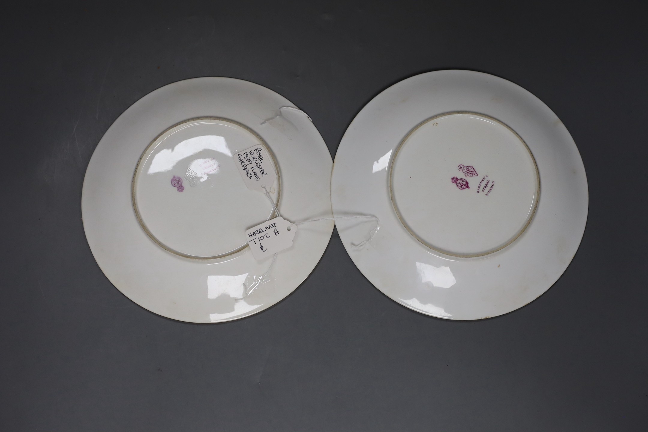 Three Royal Worcester Aesthetic period plates, with raised gilded and enamelled botanical decoration, on a floral ground, originally retailed by Gardner’s Strand, London. 23cm diameter.